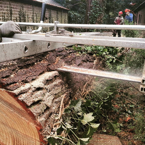 Close view of a chainsaw mill cutting timber